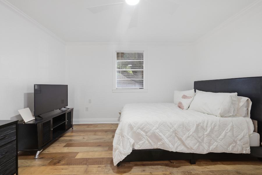 Bedroom with TV stand and window
