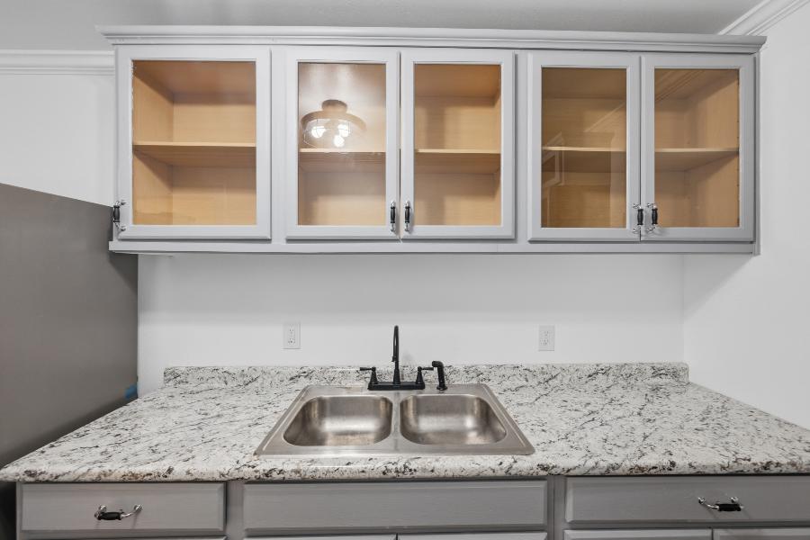 Kitchen sink with glass-front cabinets