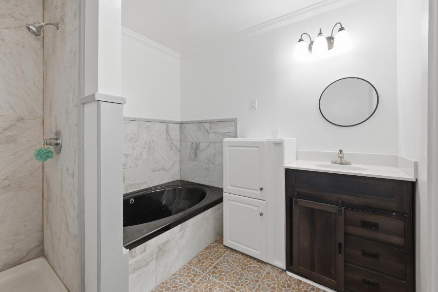 Bathroom with jetted tub and vanity