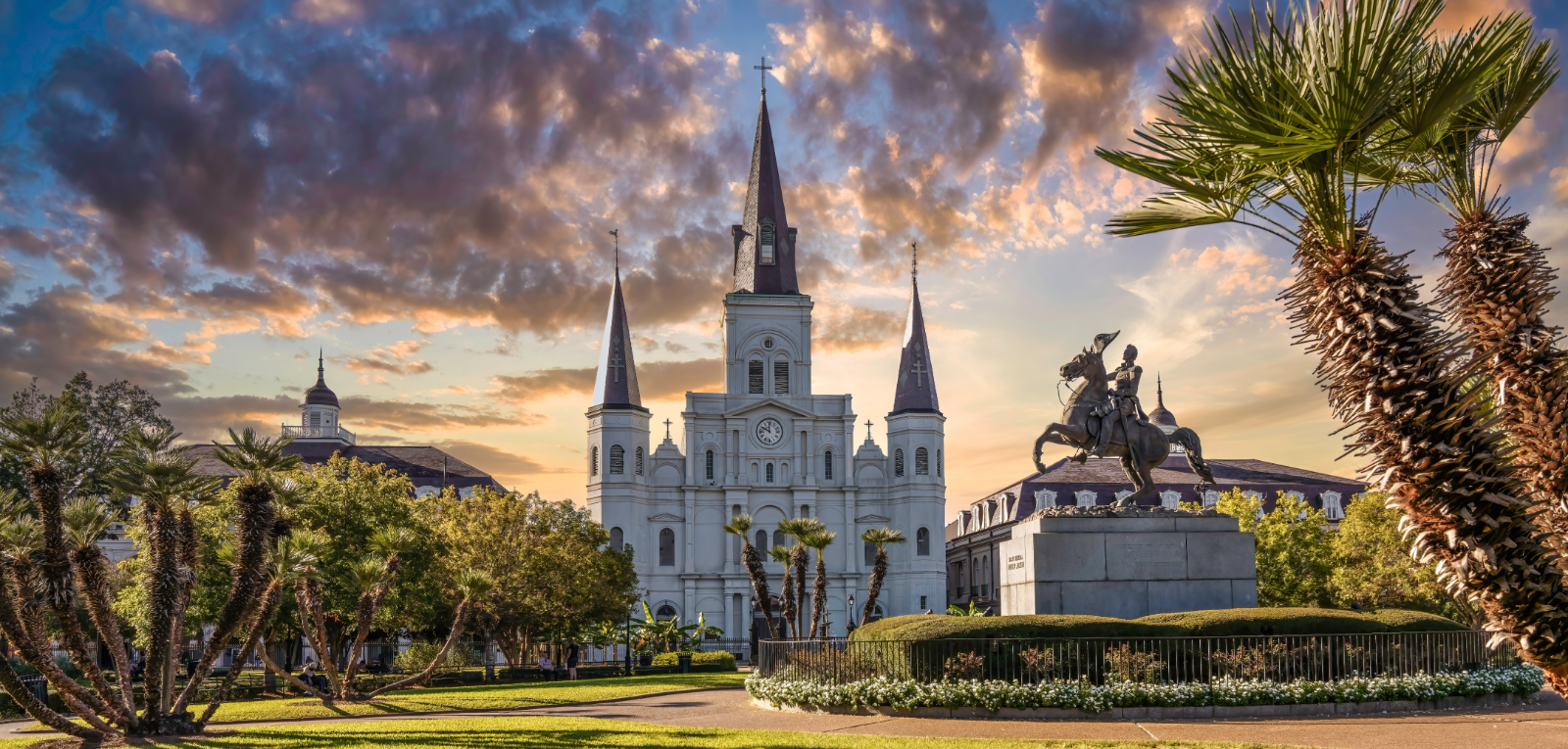 St. Louis Cathedral and Jackson Square in New Orleans under a dramatic sunset sky