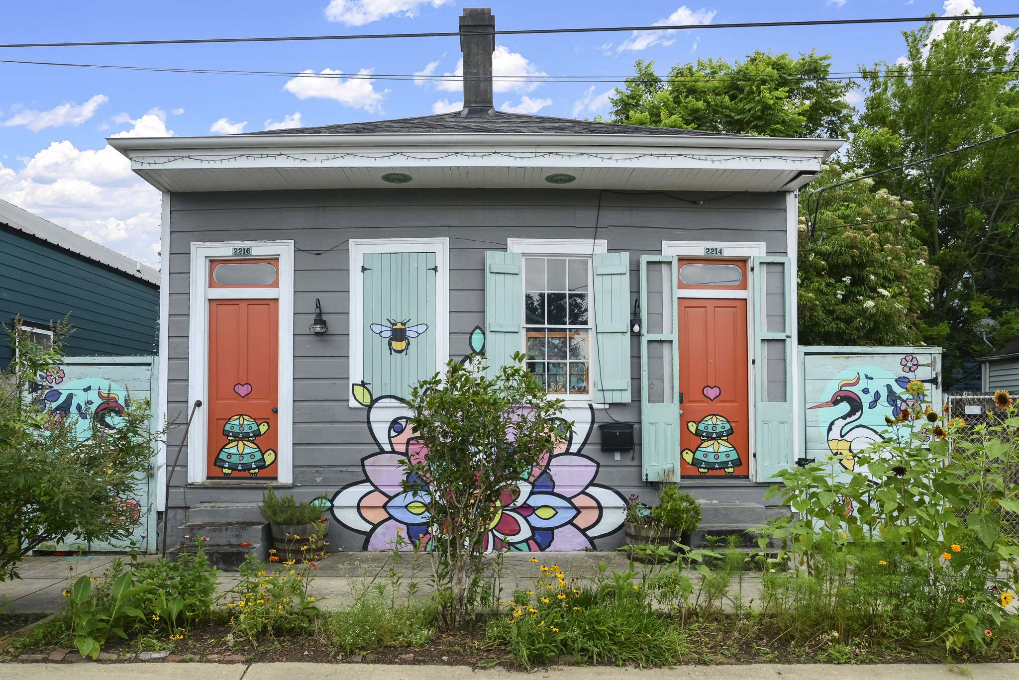 Colorful historic double shotgun house with hand-painted murals in New Orleans